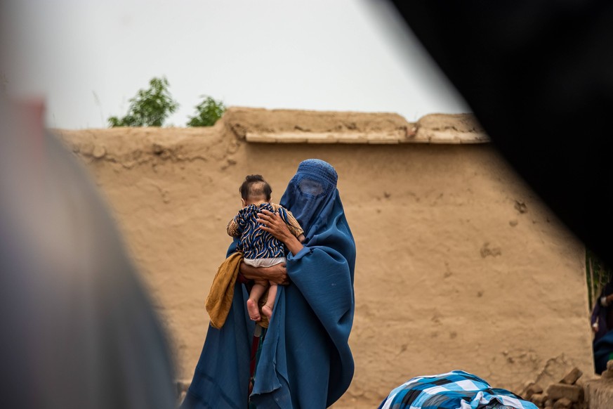 Flood in Afghanistan A woman holds her baby in their house after the flash floods devastated villages in Baghlan, Afghanistan, on May 17, 2024. The torrential rains turned into floods, devastating vil ...