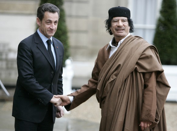 FILE - In this Dec. 10 2007 file photo, French President Nicolas Sarkozy, left, greets Libyan leader Col. Moammar Gadhafi upon his arrival at the Elysee Palace, in Paris. Former French President Nicol ...