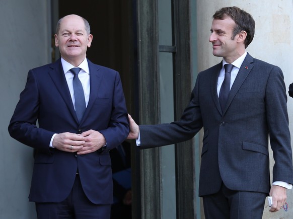 French President Emmanuel Macron (R) greets German Chancellor Olaf Scholz as he arrives at the Elysee Palace in Paris on Friday, December 10, 2021. The visit to Paris comes just a few days after Schol ...
