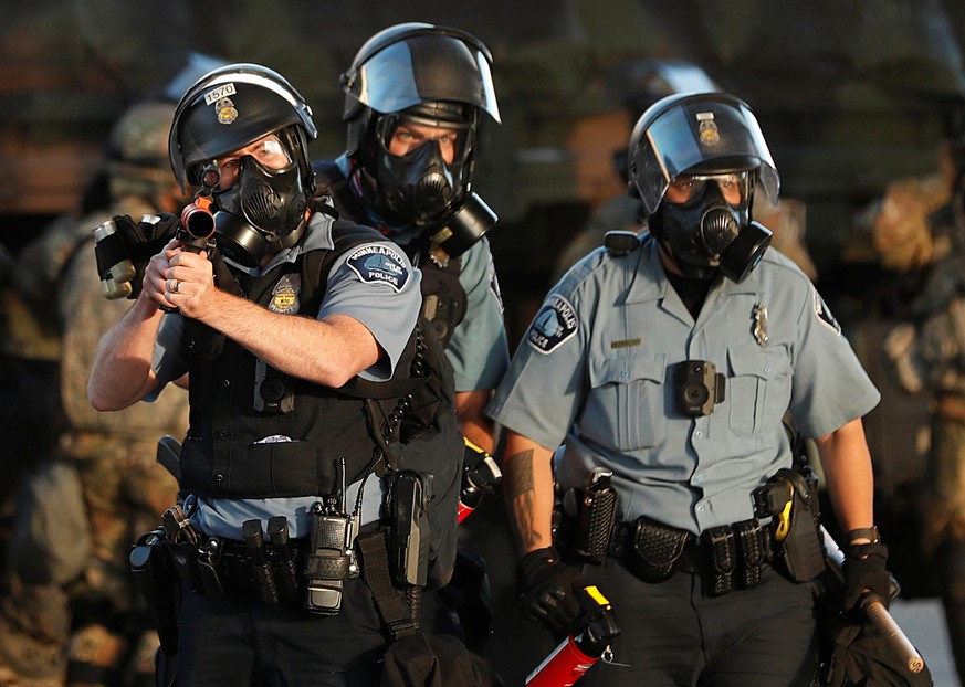 A police officer holds a tear gas launcher during a protest against the death in Minneapolis police custody of African-American man George Floyd, in Minneapolis, Minnesota, U.S., May 29, 2020. REUTERS ...