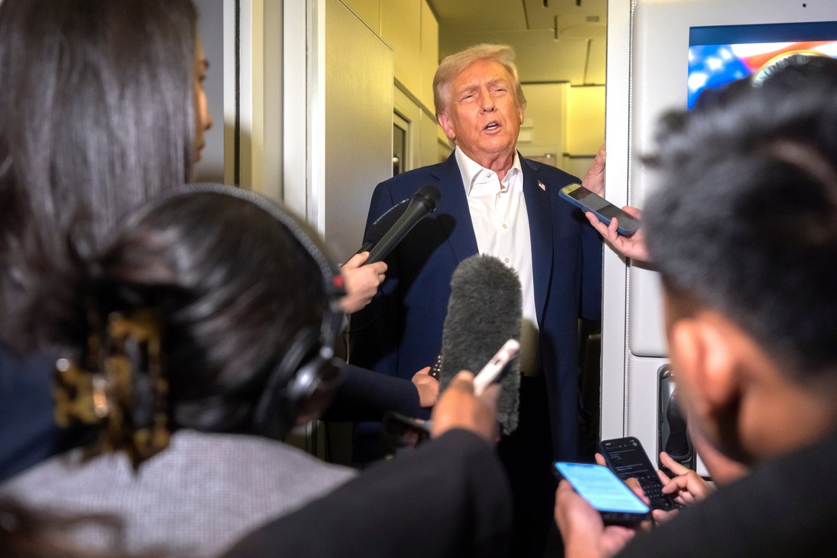 President Donald Trump speaks to reporters aboard Air Force One en route to Asia, Friday, Oct. 24, 2025. (AP Photo/Mark Schiefelbein)