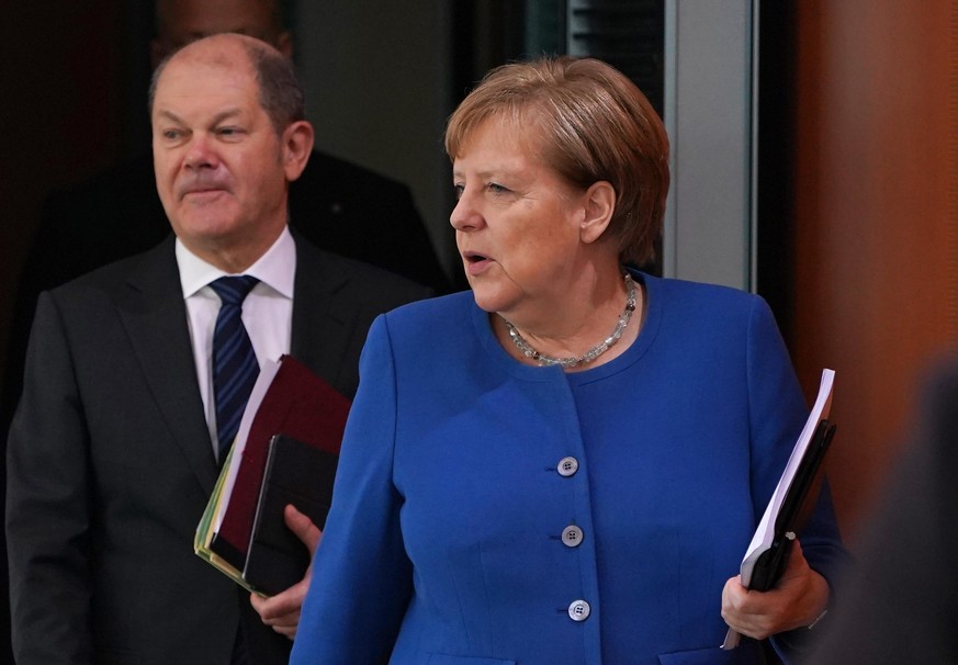 BERLIN, GERMANY - MARCH 11: German Chancellor Angela Merkel and Finance Minister and Vice Chancellor Olaf Scholz arrive for the weekly government cabinet meeting on March 11, 2020 in Berlin, Germany.  ...