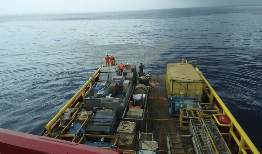 In this photo released by Indonesian Disaster Mitigation Agency (BNPB) rescuers inspect oi slick debris believed to be from Lion Air passenger jet that crashed off West Java on Monday, Oct. 29, 2018.  ...