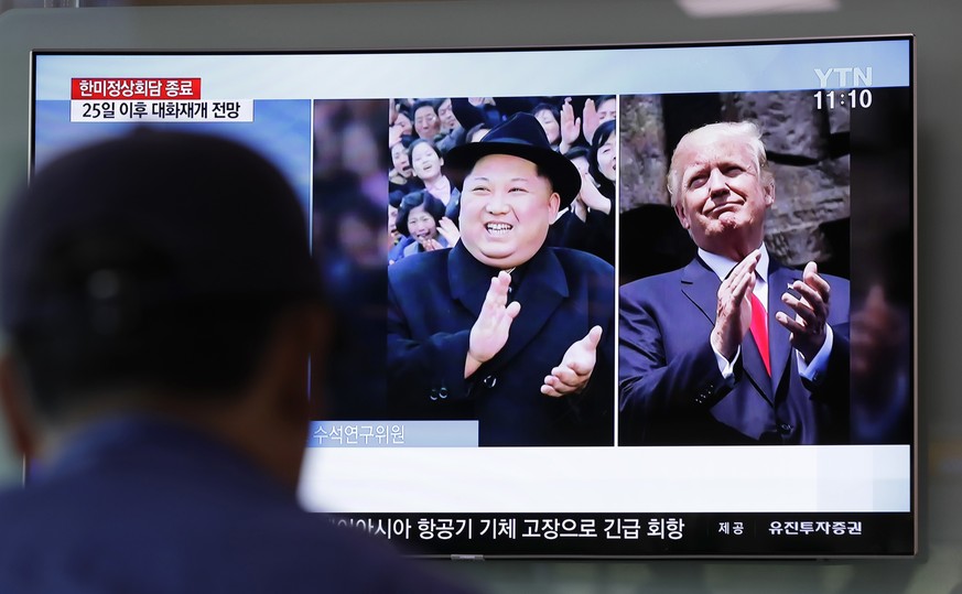 A man watches a TV screen showing file footage of U.S. President Donald Trump, right, and North Korean leader Kim Jong Un, left, during a news program at the Seoul Railway Station in Seoul, South Kore ...