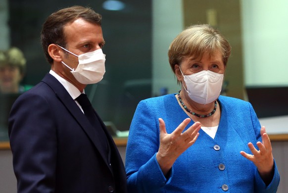 BRUSSELS, BELGIUM - JULY 18: French President Emmanuel Macron (L) and German Chancellor Angela Merkel (R) attend EU summit to discuss EU's long-term budget and coronavirus recovery plan in Brussels, B ...