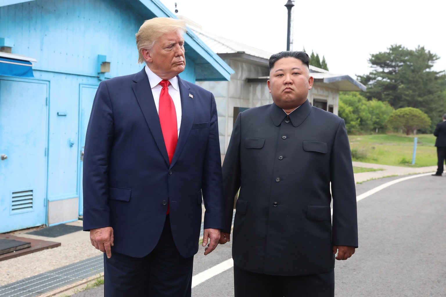 PANMUNJOM, SOUTH KOREA - JUNE 30 (SOUTH KOREA OUT): A handout photo provided by Dong-A Ilbo of North Korean leader Kim Jong Un and U.S. President Donald Trump inside the demilitarized zone (DMZ) separ ...