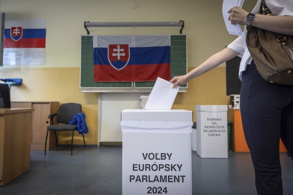 A woman casts her ballot during European Parliamentary elections in Bratislava, Slovakia, Saturday, June 8, 2024. Voters in Slovakia are casting the ballots in European Parliamentary elections just we ...