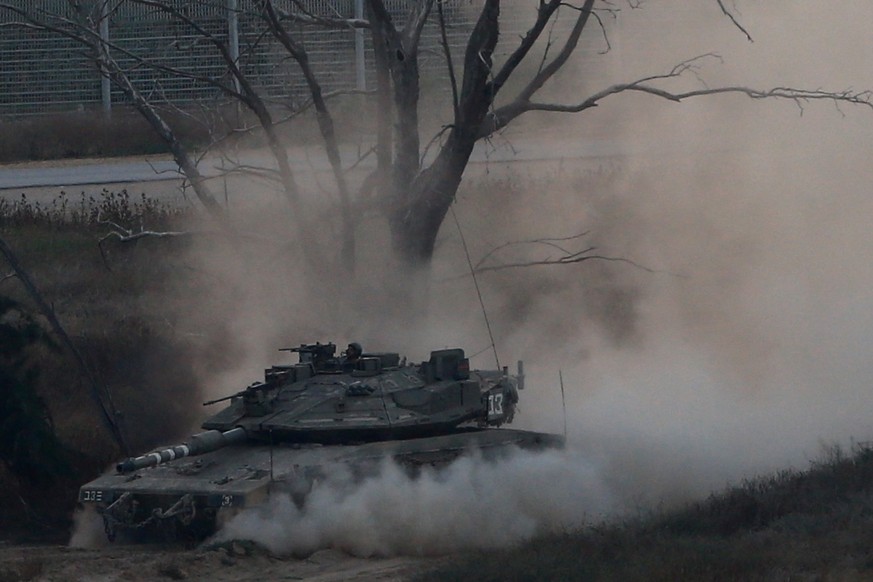 An Israeli tank drives along the border with the Gaza strip, on Israel-Gaza Border, Tuesday, May 29, 2018. Palestinian militants in the Gaza Strip fired at least 50 rockets and mortars into southern I ...