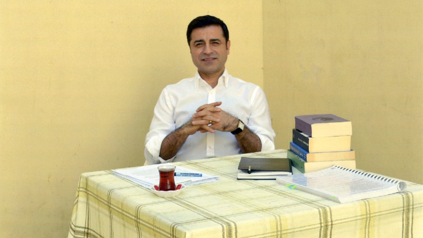In this handout photo provided by the pro-Kurdish Peoples' Democratic Party (HDP), former co-leader of the party Selahattin Demirtas sits in prison in Turkey, Friday, May 4, 2018. The HDP announced th ...