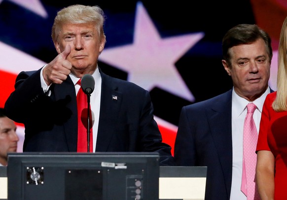 FILE PHOTO: Republican presidential nominee Donald Trump gives a thumbs up as his campaign manager Paul Manafort looks on during Trump's walk through at the Republican National Convention in Cleveland ...