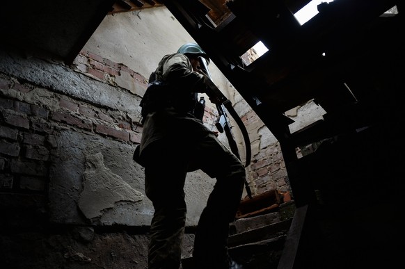 May 31, 2023, Kyiv, Donetsk Oblast, Ukraine: A Ukrainian solider climbs stairs to take a defensive position at the entrance of a frontline position. Russian troops have been launching probing attacks  ...