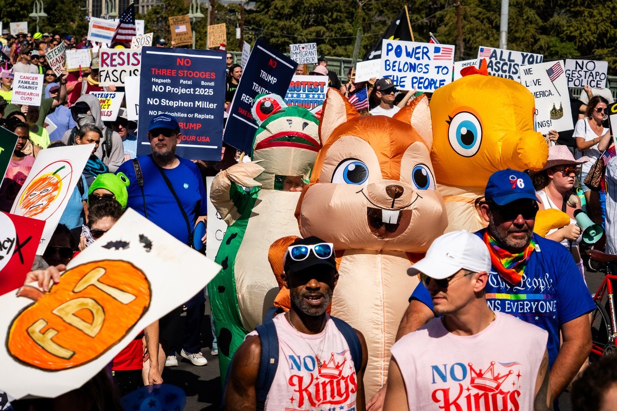 Protesters march through downtown Austin for the &quot;No Kings&quot; rally on Saturday, Oct. 18, 2025. (Sara Diggins/Austin American-Statesman via AP)