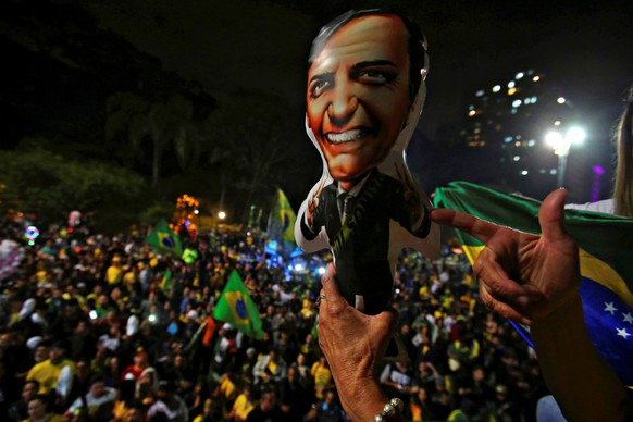 Supporters of Jair Bolsonaro, far-right lawmaker and presidential candidate of the Social Liberal Party (PSL), react after Bolsonaro wins the presidential race, in Sao Paulo, Brazil October 28, 2018. ...