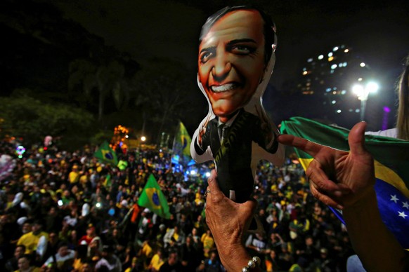 Supporters of Jair Bolsonaro, far-right lawmaker and presidential candidate of the Social Liberal Party (PSL), react after Bolsonaro wins the presidential race, in Sao Paulo, Brazil October 28, 2018.  ...