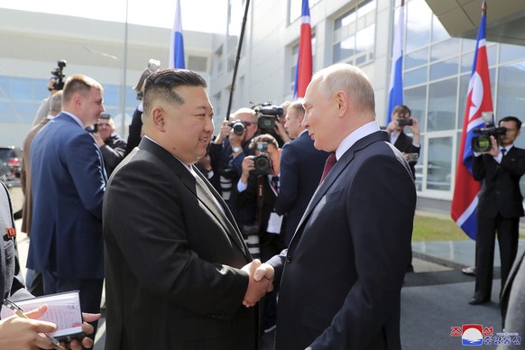In this photo provided by the North Korean government, Russian President Vladimir Putin, right, welcomes North Korean leader Kim Jong Un at the Vostochny cosmodrome outside the city of Tsiolkovsky, ab ...
