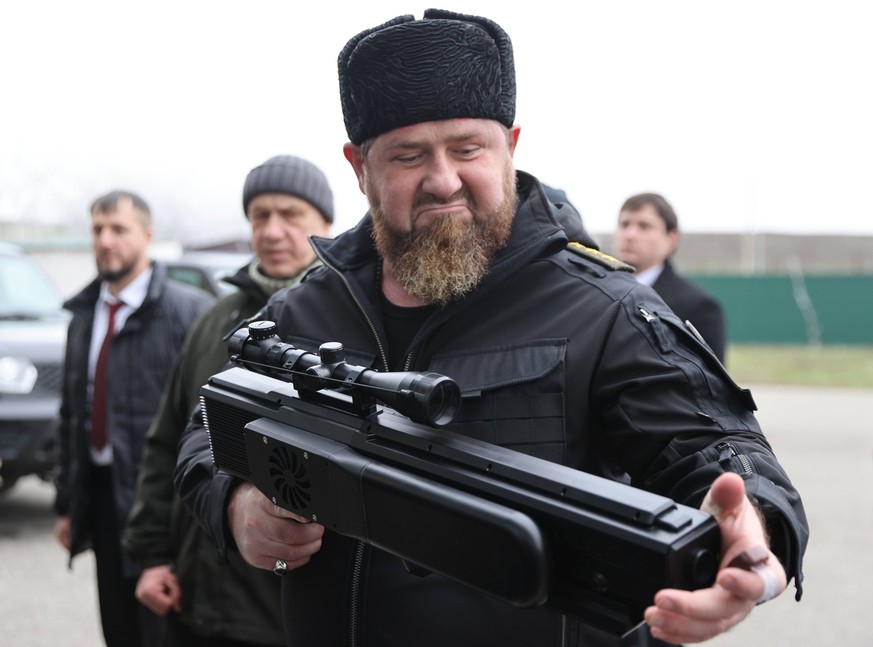 RUSSIA, CHECHEN REPUBLIC - DECEMBER 25, 2022: Ramzan Kadyrov front, head of the Chechen Republic, examines weapons during a meeting with Kremlin First Deputy Chief of Staff Sergei Kiriyenko and Russia ...