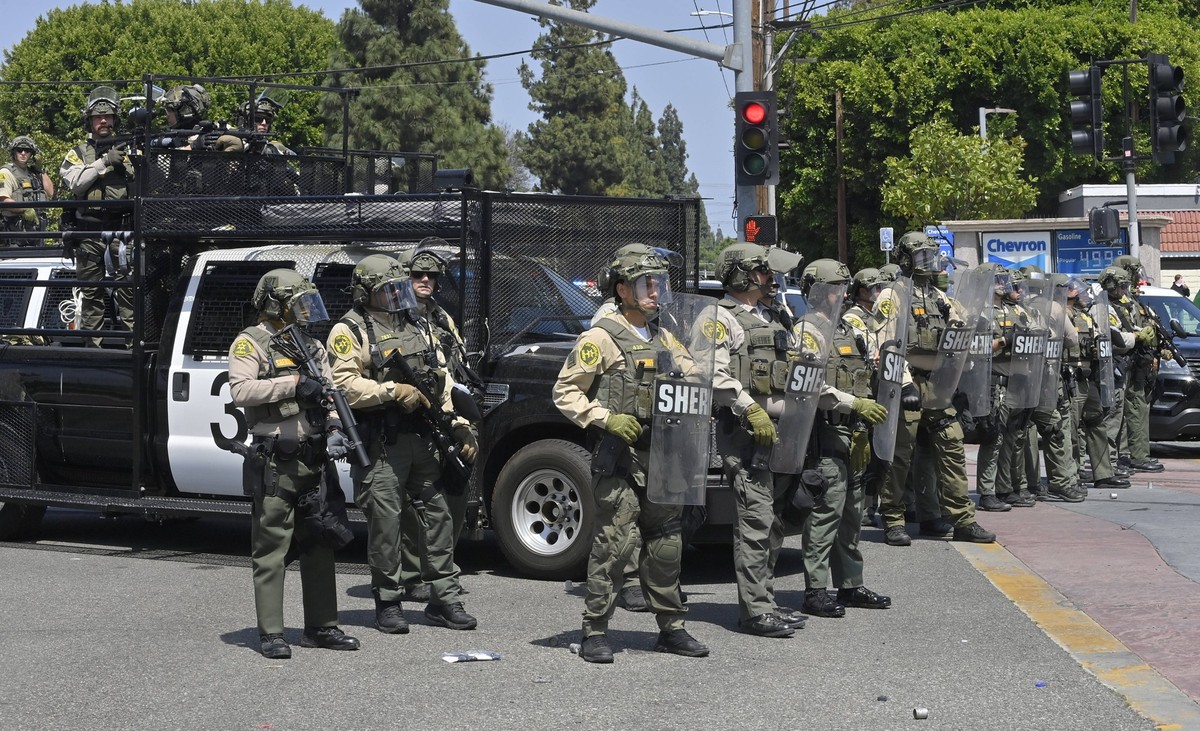 Protestors face off with California Highway Patrol officers during a protest against ICE and immigration raids on the Alvarado Boulevard Long Beach 710 Freeway in Paramount, California on Saturday, Ju ...