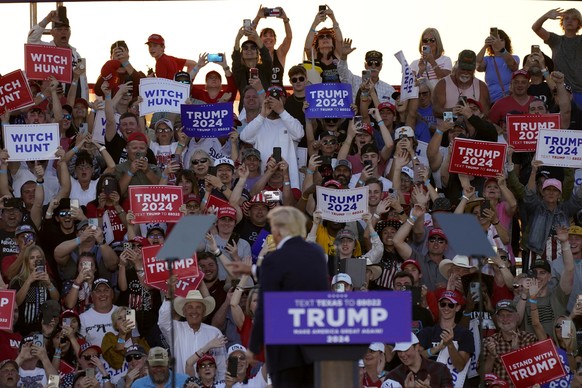 Supporters cheer former President Donald Trump as speaks at a campaign rally at Waco Regional Airport Saturday, March 25, 2023, in Waco, Texas. (AP Photo/Nathan Howard)