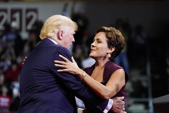 Former President Donald Trump, left, gives Kari Lake, who is running for the Republican gubernatorial nomination in Arizona, a hug as Trump speaks at a Save America rally Friday, July 22, 2022, in Pre ...