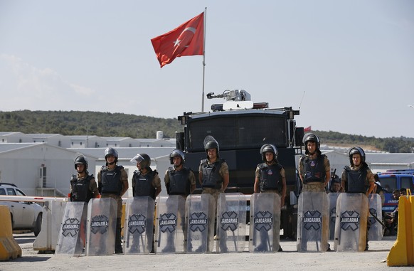 Turkish police officers secure the entrance of Istanbul new airport construction site in Istanbul, Saturday, Sept.15, 2018. A trade union leader says police in Turkey have rounded up hundreds of const ...