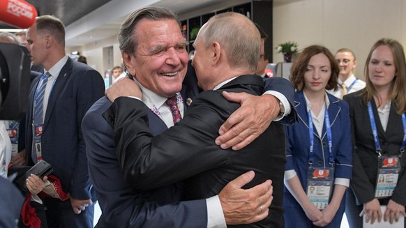 MOSCOW, RUSSIA - JUNE 14, 2018: Russia&#039;s President Vladimir Putin (R) hugs Gerhard Schroeder, Chairman of the Shareholders Committee with Nord Stream 2 AG and former German chancellor, at the ope ...