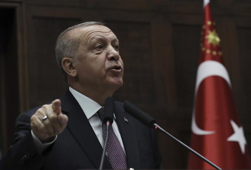 Turkish President Recep Tayyip Erdogan addresses his ruling Justice and Development Party legislators at the Parliament, in Ankara, Tuesday, Nov. 19, 2019. (AP Photo/Burhan Ozbilici)