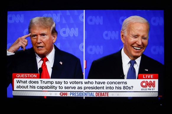 June 28, 2024, Atlanta, United States: This photo taken from a screen shows the first presidential debate between US President Joe Biden and former President Donald Trump in the CNN studio in Atlanta. ...