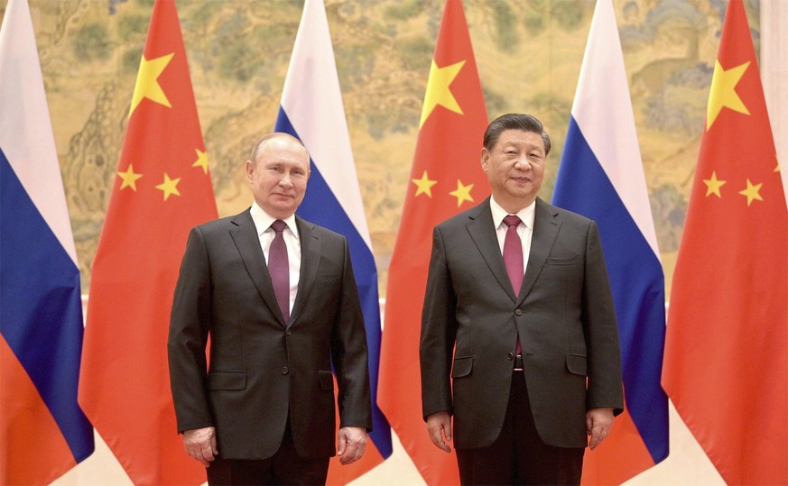 February 4, 2022, Beijing, China: Russian President Vladimir Putin stands with Chinese President Xi Jinping, before the start of their bilateral meeting at the Diaoyutai State Guesthouse, February 4,  ...