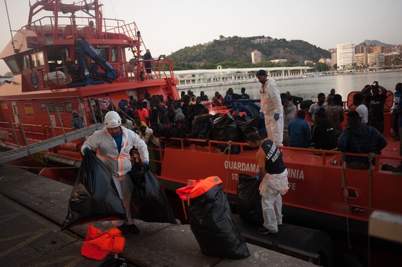 June 23, 2018 - Malaga, Malaga, Spain - Migrants, who were rescued from a dinghy in the Mediterranean Sea, stand aboard of the rescue boat after their arrival at Port of Malaga. Members of the Spanish ...