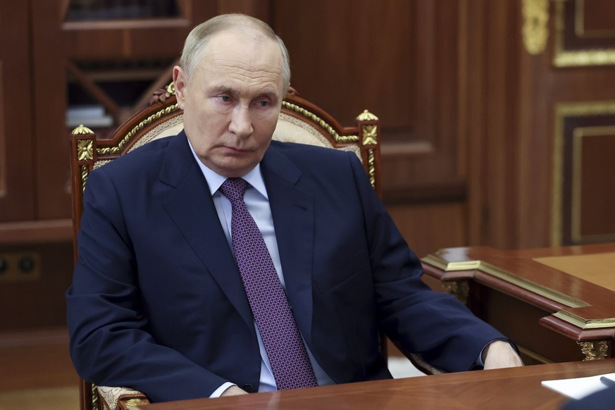 Russian President Vladimir Putin listens to the head of the United Russia party&#039;s faction Vladimir Vasilyev in the State Duma, the Lower House of the Russian Parliament during their meeting at th ...