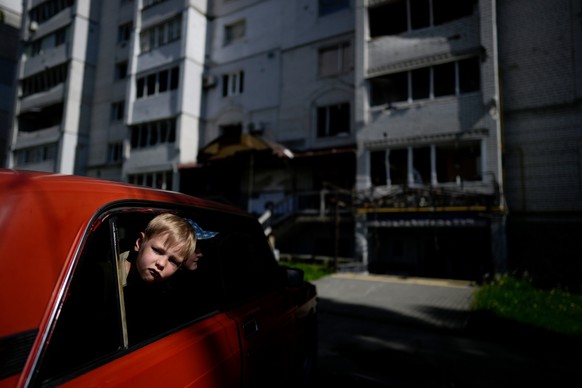dpatopbilder - 31.05.2022, Ukraine, Borodjanka: Zwei Kinder warten in einem Auto auf ihre Verwandten vor einem durch Angriffe zerst