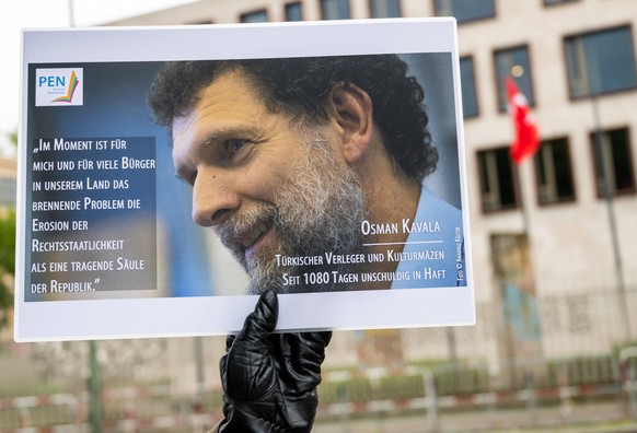 Ein Mann hält bei einer Mahnwache des PEN-Zentrums für den türkischen Verleger und Kulturmäzen Osman Kavala vor der Türkischen Botschaft ein Bild von Kavala. Kavala wurde Ende 2017 in der Türkei verha ...