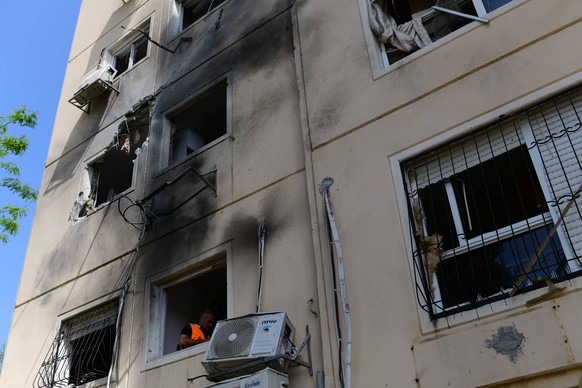 210511 -- ASHKELON, May 11, 2021 -- A damaged building hit by a rocket from the Gaza Strip is seen in southern Israeli city of Ashkelon, May 11, 2021. Since 6 p.m. local time 1500 GMT on Monday after  ...