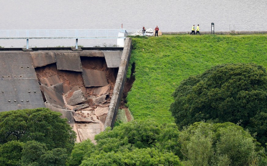The damage of a dam is seen after a nearby reservoir was affected by flooding, in Whaley Bridge, Britain August 1, 2019. REUTERS/Phil Noble