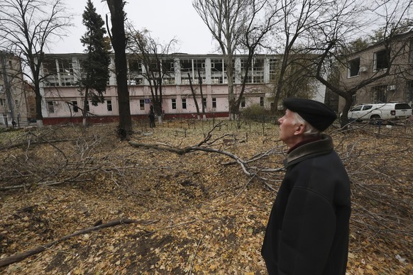 A man stands near a crater in front of a sports center damaged by a Russian strike in Zaporizhzhia, Ukraine, Nov. 11, 2024. (AP Photo/Kateryna Klochko)