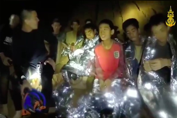 Members of the Royal Thai Navy are pictured with the 12 schoolboys, members of a local soccer team, and their coach, who were trapped in the Tham Luang Cave network in Northern Thailand. Two British v ...