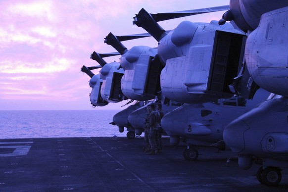 Marines from the 26th Expeditionary Unit stand next to MV22 Ospreys tiltrotor military aircraft on the deck of the USS Bataan in the Aegean Sea, Greece, Friday, Jan. 19, 2024. The Bataan, an amphibiou ...