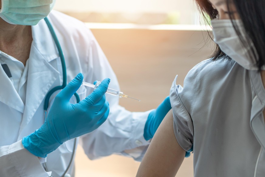 Immunization and vaccination for flu shot, influenza, HPV or Covid-19 prevention with young child girl having vaccine injection for World immunization week and International HPV awareness day