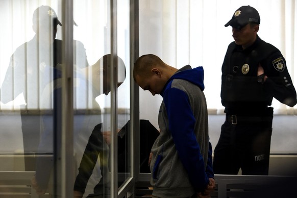 Russian soldier Vadim Shishimarin, 21, suspected of violations of the laws and norms of war, inside a cage during a court hearing, amid Russia's invasion of Ukraine, in Kyiv, Ukraine May 20, 2022 (Pho ...