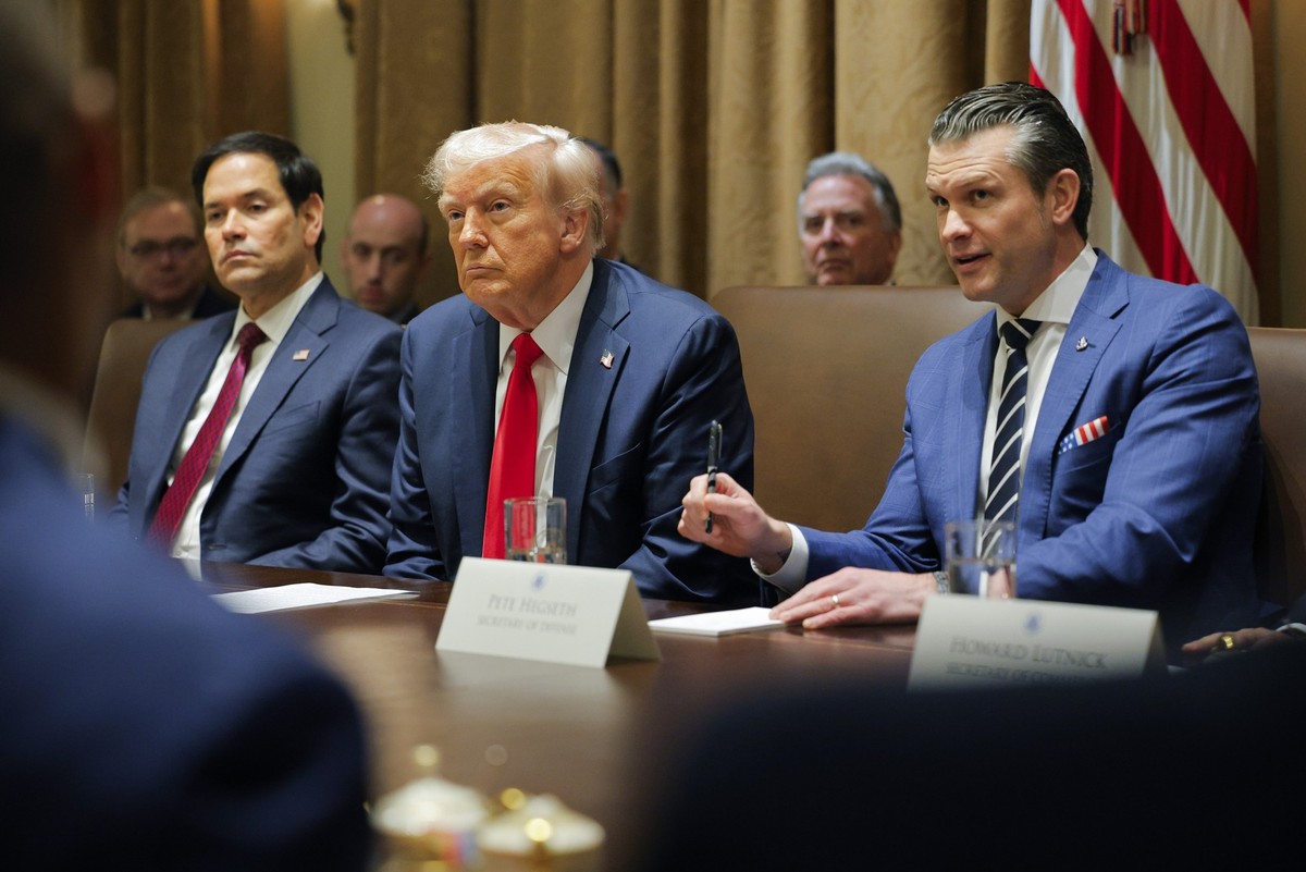 President Donald Trump listens during a Cabinet meeting at the White House in Washington, Tuesday, Feb. 26, 2025, as Secretary of State Marco Rubio and Defense Secretary Pete Hegseth listen. (Pool via ...