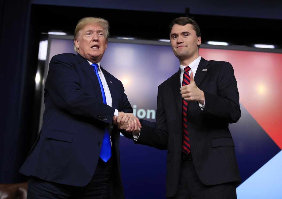FILE - President Donald Trump shakes hands with moderator Charlie Kirk, during a Generation Next White House forum at the Eisenhower Executive Office Building on the White House complex in Washington, ...