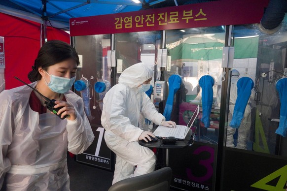 Single-person COVID-19 testing booth, Mar 18, 2020 : Medical team works at a single-person COVID-19 testing facilities outside a hospital in Seoul, South Korea. The H-plus Yangji Hospital set up publi ...