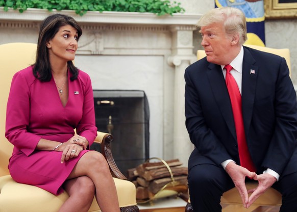 U.S. President Donald Trump talks with U.N. Ambassador Nikki Haley in the Oval Office of the White House after it was announced the president had accepted the Haley's resignation in Washington, U.S.,  ...