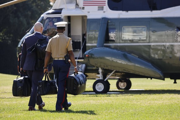 Biden Departs for Maryland and Pennsylvania A U.S. Marine Corps officer military aide carries the nuclear launch codes known as the football, as he follows President Joe Biden onto Marine One on the S ...