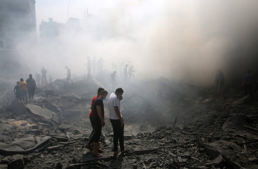 Palestinian search the rubble of destroyed buildings following an Israeli strike Palestinian search the rubble of destroyed buildings following an Israeli strike, as battles between Israel and the Ham ...
