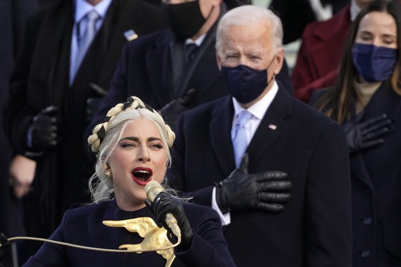 Lady Gaga performs the National Anthem as President-elect Joe Biden watches during the 59th Presidential Inauguration at the U.S. Capitol in Washington, Wednesday, Jan. 20, 2021. (AP Photo/Andrew Harn ...