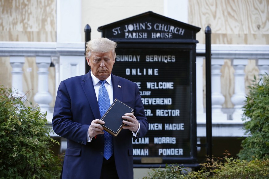 President Donald Trump holds a Bible as he visits outside St. John's Church across Lafayette Park from the White House Monday, June 1, 2020, in Washington. Part of the church was set on fire during pr ...