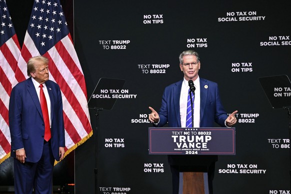 Republican presidential nominee former President Donald Trump, left, listens as investor Scott Bessent speaks on the economy in Asheville, N.C., Wednesday, Aug. 14, 2024. (AP Photo/Matt Kelley)