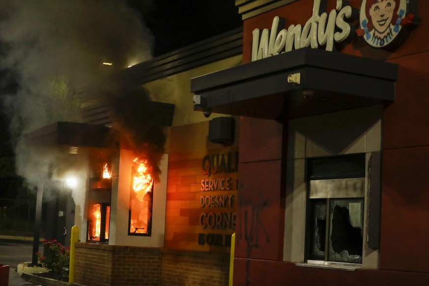 A Wendy's restaurant is on fire during protests on Saturday, June 13, 2020, where Rayshard Brooks was shot and killed by police Friday evening following a struggle in the restaurant's drive-thru line  ...