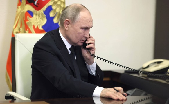 March 23, 2024. - Russia, Moscow. - Russian President Vladimir Putin speaks on the phone as he addresses Russian citizens following a terrorist attack at the Crocus City Hall in the town of Krasnogors ...